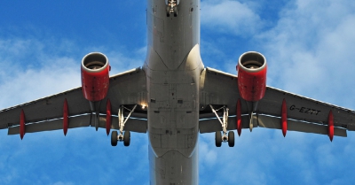 a aeroplane with red turbines flying over the camera