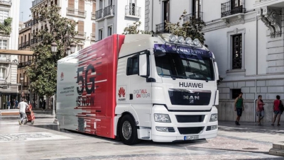 5G consortium video filming, shows a huge Huawei lorry with '5G is now' written on the side