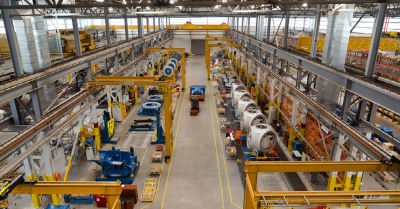 a factory with yellow beams and various machinery