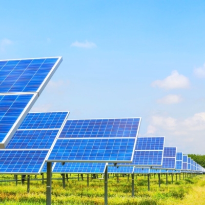 A group of solar panels in a green field