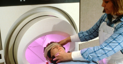 a person is being sent into a scan machine