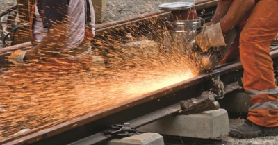 a train track repair in progress with sparks flying