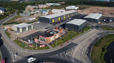 A retail park photographed from above, with several roads weaving through it